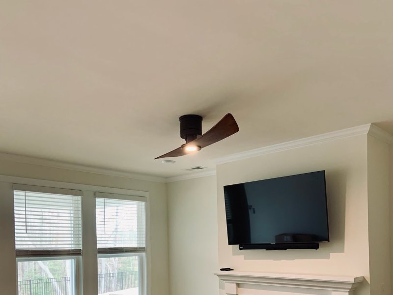 brown ceiling fan in home with television