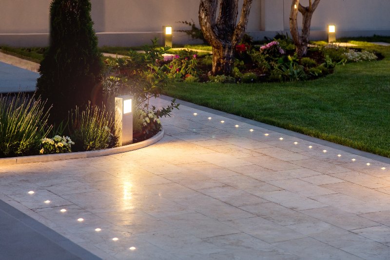 gray walking path with outdoor lighting