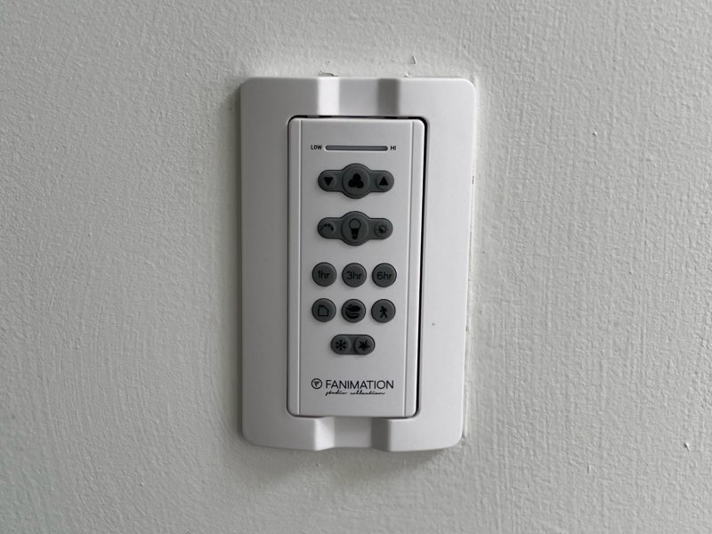 white ceiling fan controller on wall